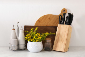 Wooden kitchenware and mimosa flowers on countertop indoors