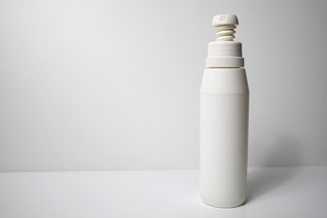 A white hand disinfection spray bottle for rotection against COVID-19 corona virus.