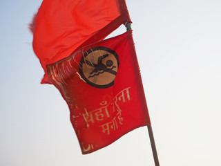 A red flag about the ban on swimming is developed by the wind close-up in India on the shore.