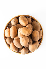 Healthy Food concept organic raw potatoes in the bamboo basket isolated on white background