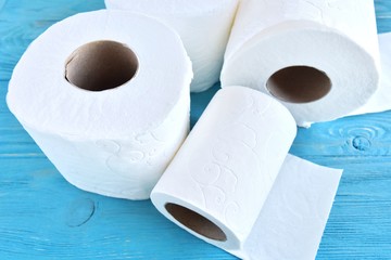 roll of soft toilet paper with selective focus on blue wooden background. toilet paper for Covid-19 pandemic. Increased potential. high demand