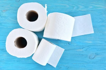 roll of soft toilet paper with selective focus on blue wooden background. toilet paper for Covid-19 pandemic. Increased potential. high demand