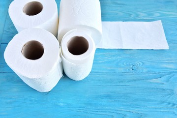 roll of soft toilet paper with selective focus on blue wooden background. toilet paper for Covid-19 pandemic. Increased potential. high demand