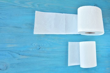 roll of soft toilet paper with selective focus on blue wooden background. toilet paper for Covid-19 pandemic. Increased potential. high demand