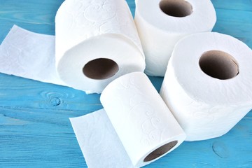 roll of soft toilet paper with selective focus on blue wooden background. toilet paper for Covid-19 pandemic. Increased potential. high demand