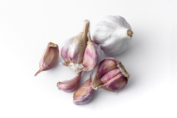 garlic cloves and garlic bulb and white background