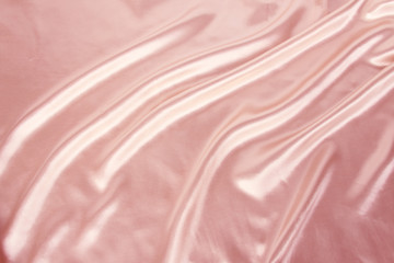 Obraz premium soft folds on delicate pink shining silk, luxury concept, background for the designer, horizontal, close-up, copy space