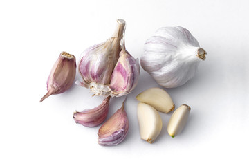 garlic cloves and garlic bulb and white background