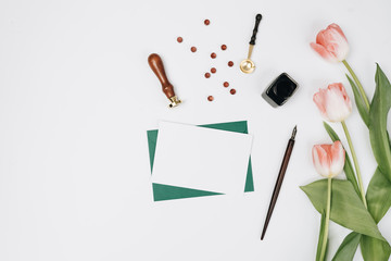 Envelopes, gifts and tulips on white background