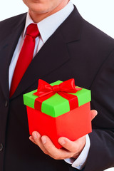 businessman holding gift box with red bow