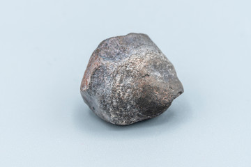Fototapeta premium Chondrite Meteorite L6W2 Type isolated, piece of rock formed as an asteroid in the universe at during Solar System creation. The meteorite comes from an asteroid fall impacting Earth at Atacama Desert