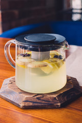 The kettle is on the table in the cafe in it is clogged with herbal tea