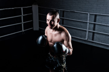Portrait of kickboxer occupying an opponent in the ring. Sports concept, Muay Thai.