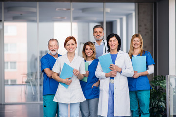 Group of doctors standing in corridor on medical conference.