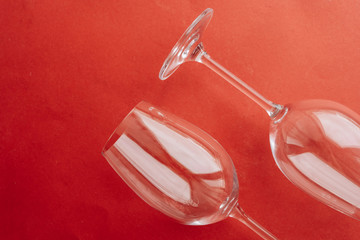 pair of clean wineglasses on red background