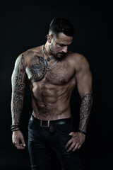 Beautiful male torso. Men tattoo casual fashion. muscular bodybuilder posing. sexy portrait of sport man. Tattooed muscular guy posing in studio. Workout for good health. Prank to abdominal muscles