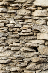 Background of limestone masonry. The surface is decorated with natural material. The wall is made of wild stone.