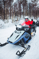 Woman at Snowmobile in Winter Finland Lapland at Christmas
