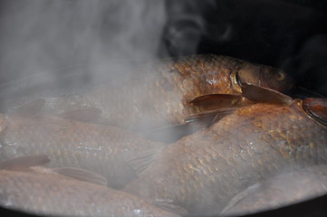 fish just caught and cooked and smoked in nature