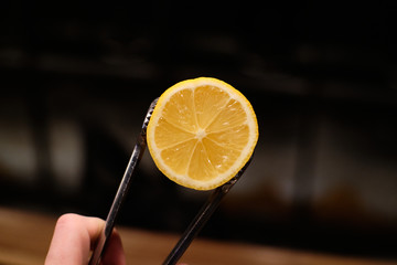 half of lemon on the tongs