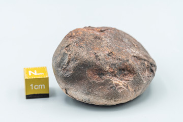 Obraz premium Chondrite Meteorite L6W2 Type isolated, piece of rock formed as an asteroid in the universe at during Solar System creation. The meteorite comes from an asteroid fall impacting Earth at Atacama Desert