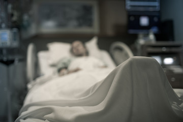 Sick woman in hospital bed unrecognizable. 