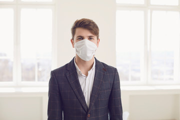 Danger of infection of the virus coronavirus infection. Businessman in medical mask at office