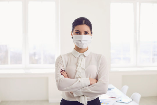 Danger of infection of the virus coronavirus infection. Businesswoman in medical mask at office