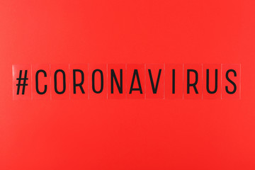 Word coronavirus and hashtag on red background. Stop Coronavirus social media movement concept. Flat lay, top view.