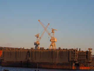 view of the cargo port with floating cranes