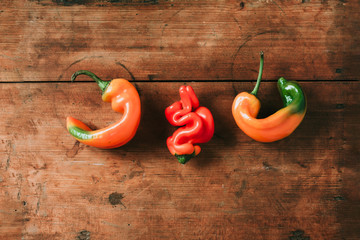 Ugly bell pepper on wooden background. Concept of zero waste production. Top view. Copy space. Non...