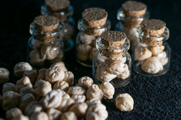 macro photography of raw chickpeas in glass jars