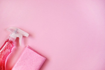 Detergents in spray. Сleaning accessories. Top view of pink cleaning supplies on pink background. Close up.