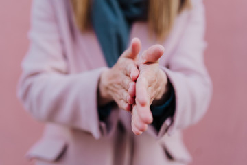 caucasian woman in the street using an alcohol gel or antibacterial disinfectant on hands. Hygiene and corona virus concept