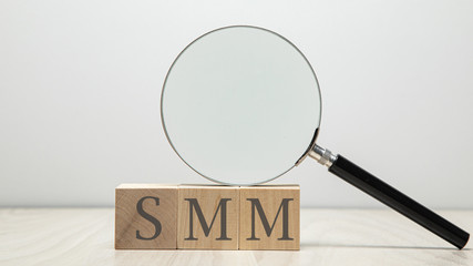 SMM - Social Media Marketing abbreviation on wooden cubes