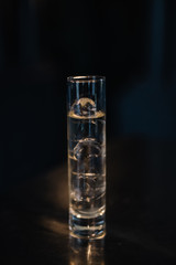 Gin and tonic cocktail in a highball glass. Dark background. Smooth image with shallow depth of field. 