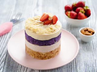 cake with cream and strawberries. Raw dessert with berries. Strawberries and almonds. Layer cake.