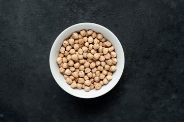  chickpeas in a bowl on a stone background