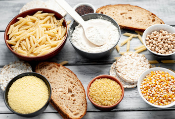 Selection of gluten free food. Chickpeas, bread, couscous, bulgur, pasta, bread, flour, quinoa  on wood background