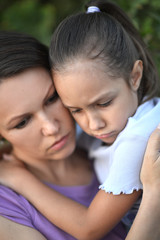 Fototapeta premium Close up portrait of sad woman and girl hugging