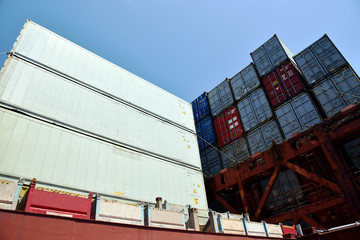 Stack of containers with cargo, loaded on deck of the container ship. International shipping of the goods and medical supplies.