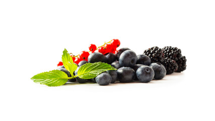 Fruits and berries isolated on white background. Fruits and berries with copy space for text. Red currants, blueberries and blackberries. Mix berries isolated on white background. 