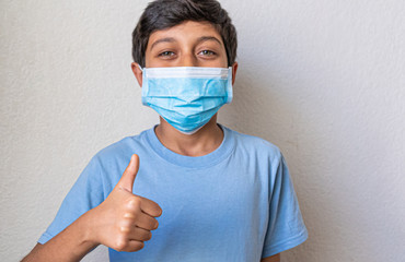 great boy with blue shirt preventing corona virus