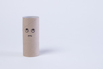 empty toilet paper roll with angry and sad face because the paper is gone