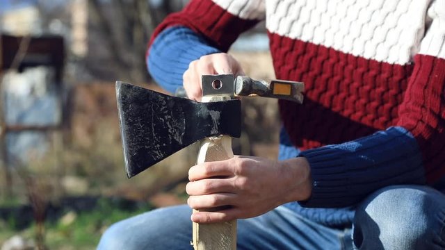 man hand ax and wood in nature