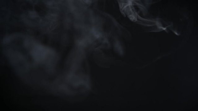 Smoke rising on black background