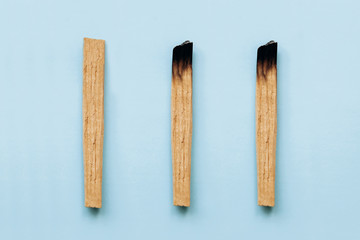 Palo Santo sticks on a blue background. They are used in aromatherapy and religious rites and meditations.