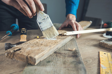 worker man hand brush paint wood