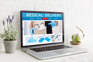 Online pharmacy. Application in your laptop for online ordering of medicines. laptop close-up. Lots of pills.