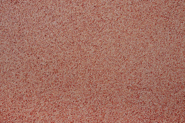 Fototapeta premium Against the background of disseminated sand small gravel, a stone crumb. Texture of a surface of a wall,light color
